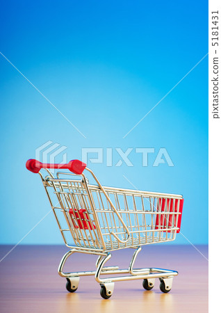 Mini shopping cart against gradient background 5181431