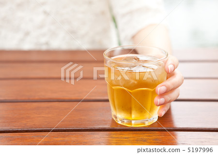 Women's hand with glass of barley tea Women's hand with glass of barley tea 5197996