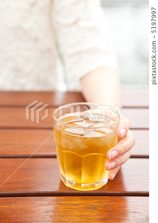 Women's hand with glass of barley tea Women's hand with glass of barley tea 5197997