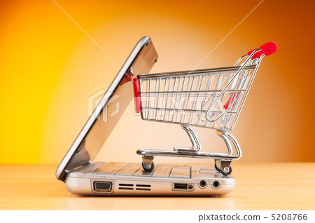 Shopping online with computer and cart 5208766