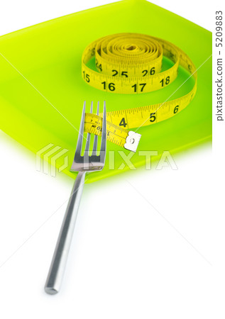 Dieting concept with fork and meter 5209883