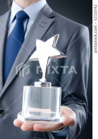 Businessman awarded with star award Businessman awarded with star award 5210542