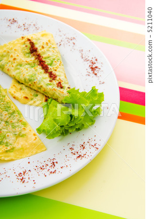 Pancake with herbs in the plate 5211040