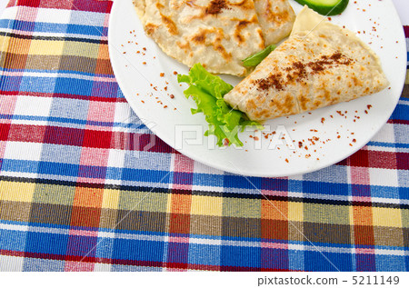 Herb stuffed pancaces in the plate 5211149