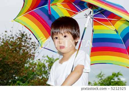 Rainbow colored umbrella and child Rainbow colored umbrella and child 5212325