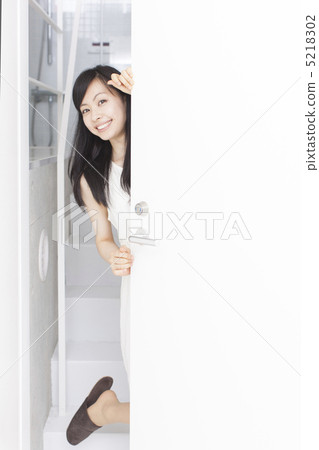 A woman looking through the door A woman looking through the door 5218302