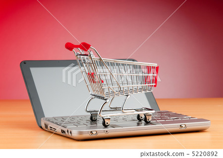 Internet online shopping concept with computer and cart 5220892
