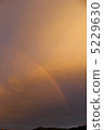 Rainbow floating in sunset 5229630