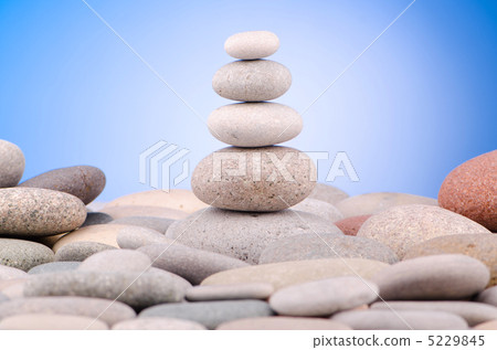 Pebbles stack against gradient background Pebbles stack against gradient background 5229845