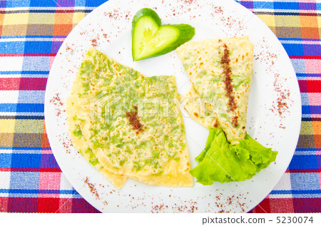 Pancake with herbs in the plate 5230074