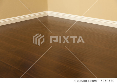 Newly Installed Brown Laminate Flooring and Baseboards in Home Newly Installed Brown Laminate Flooring and Baseboards in Home 5230370
