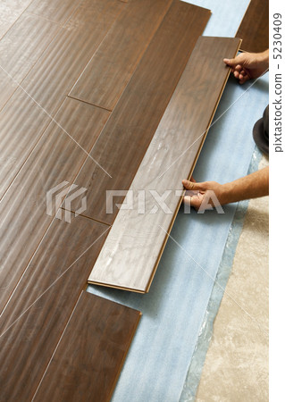 Man Installing New Laminate Wood Flooring 5230409