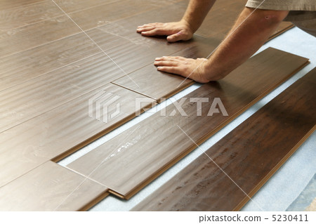Man Installing New Laminate Wood Flooring Man Installing New Laminate Wood Flooring 5230411
