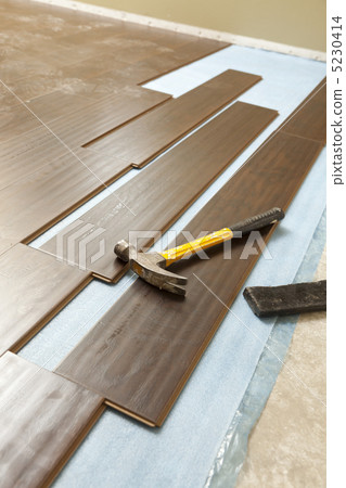 Hammer and Block with New Laminate Flooring Hammer and Block with New Laminate Flooring 5230414