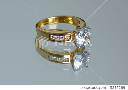 Gold diamond ring on the reflective background 5232269