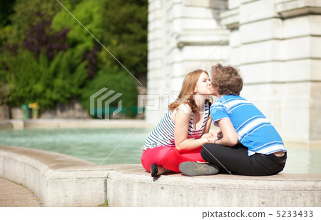 Romantic dating couple kissing by the fountain 5233433