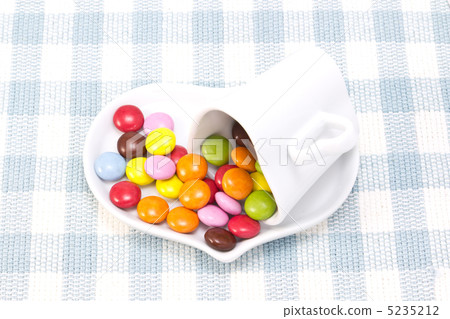 Tea cup and colorful chocolate Tea cup and colorful chocolate 5235212