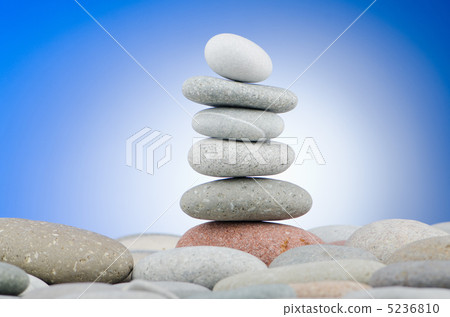 Pebbles stack against gradient background 5236810