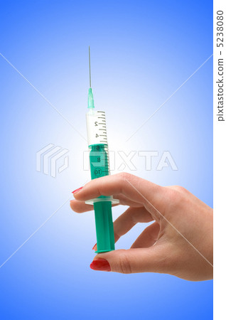 Hand holding syringe isolated on the white 5238080