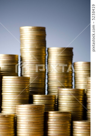 Golden coins in high stacks 5238419