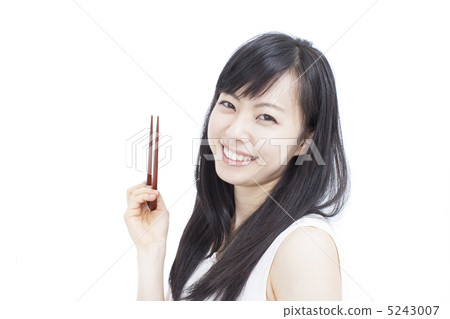 A woman holding chopsticks 5243007