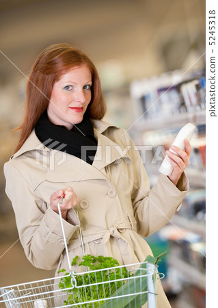Shopping series - Red hair woman buying shampoo 5245318
