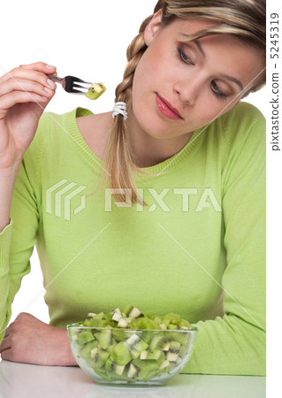 Healthy lifestyle series - Woman eating kiwi Healthy lifestyle series - Woman eating kiwi 5245319