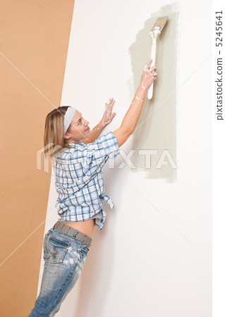 Home improvement: Woman painting wall Home improvement: Woman painting wall 5245641