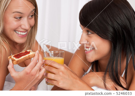Blond woman and brunette having breakfast Blond woman and brunette having breakfast 5246033