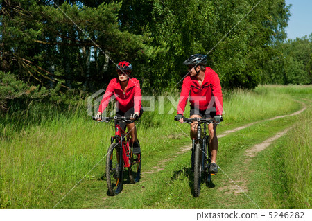 Young couple with mountine bike in spring nature Young couple with mountine bike in spring nature 5246282