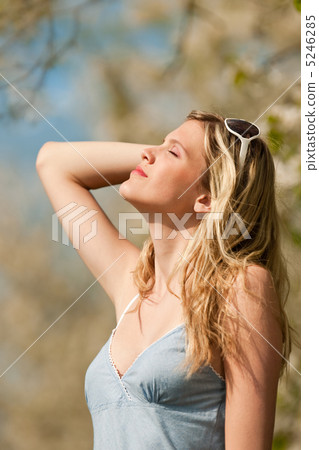 Spring - Young woman under blossom tree in orchard 5246285