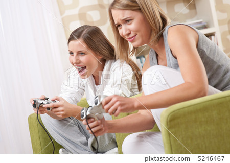 Students - Two happy female teenager playing TV game Students - Two happy female teenager playing TV game 5246467