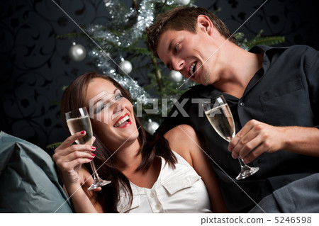 Young extravagant man and woman with champagne on Christmas 5246598