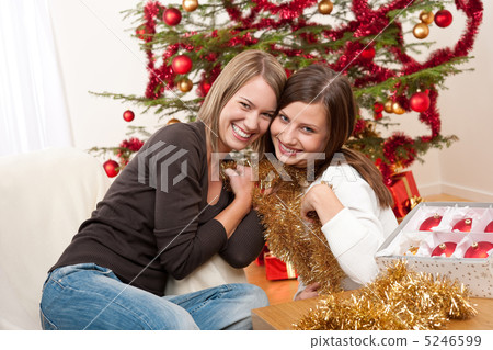 Two cheerful women with Christmas chains and balls 5246599