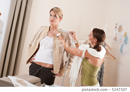 Fashion model fitting clothes by professional designer 5247387