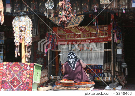 Women knitting Turkish carpets Women knitting Turkish carpets 5248463