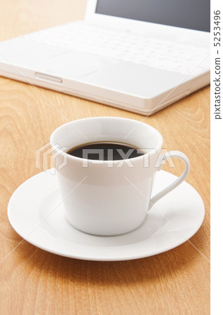 Laptop and coffee cup on table Laptop and coffee cup on table 5253496