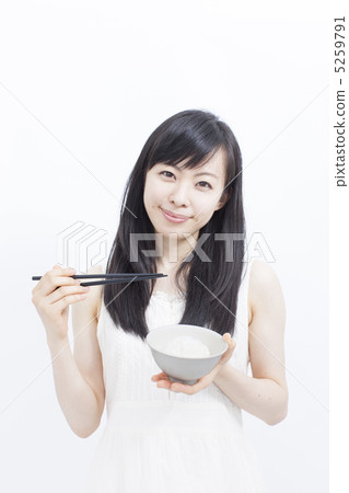 Girl eating rice 5259791