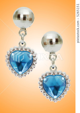 Silver earrings isolated on the white background Silver earrings isolated on the white background 5265151