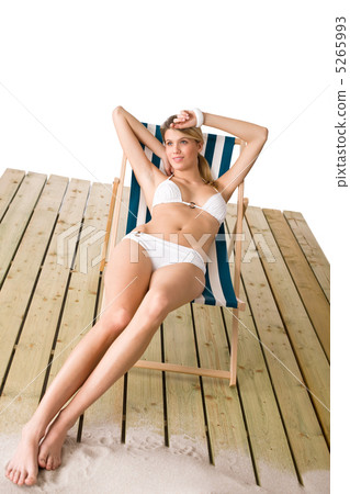 Beach - Woman in bikini sunbathing on deck chair 5265993