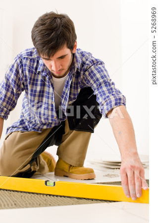 Home tile improvement - handyman with level 5268969
