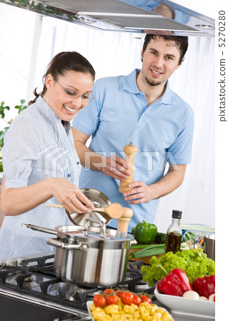 Happy couple cooking in modern kitchen Happy couple cooking in modern kitchen 5270280