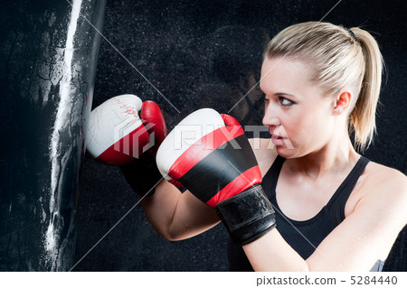 Boxing training woman with punching bag in gym Boxing training woman with punching bag in gym 5284440