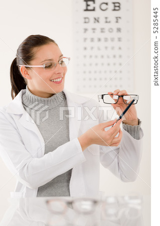 Optician doctor woman with glasses and eye chart Optician doctor woman with glasses and eye chart 5285445
