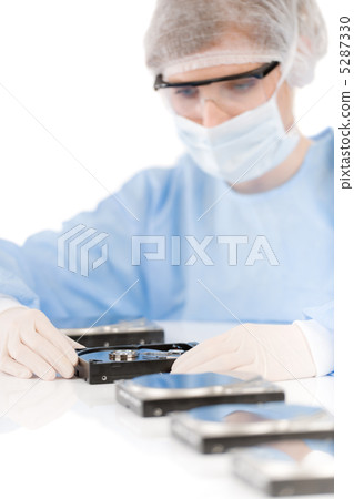 Female computer engineer - woman repair hard disc, sterile 5287330