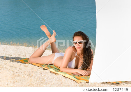 Young sexy bikini model relaxing with sunglasses 5287449