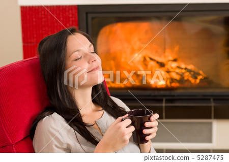 Winter home fireplace woman drink closed eyes Winter home fireplace woman drink closed eyes 5287475