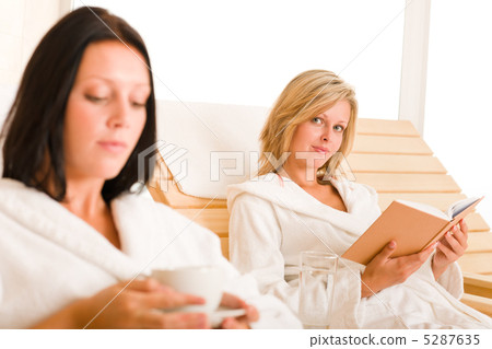 Beauty spa relax two women on sun-beds 5287635