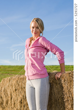 Sportive young woman relax by bales sunset 5291727