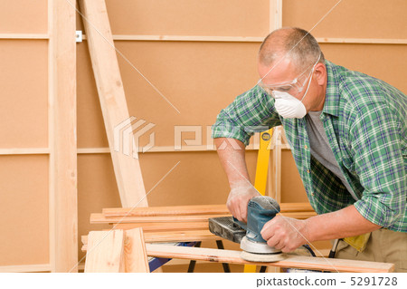 Handyman sanding wooden board diy home renovation 5291728